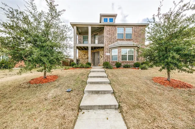 a front view of a house with a yard