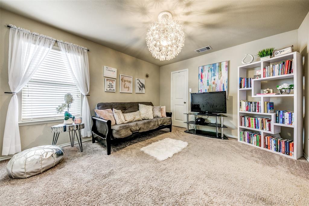 1774 Pioneer Way Lancaster, TX 75146 - Photo 15 of 23 a living room with furniture and a flat screen tv