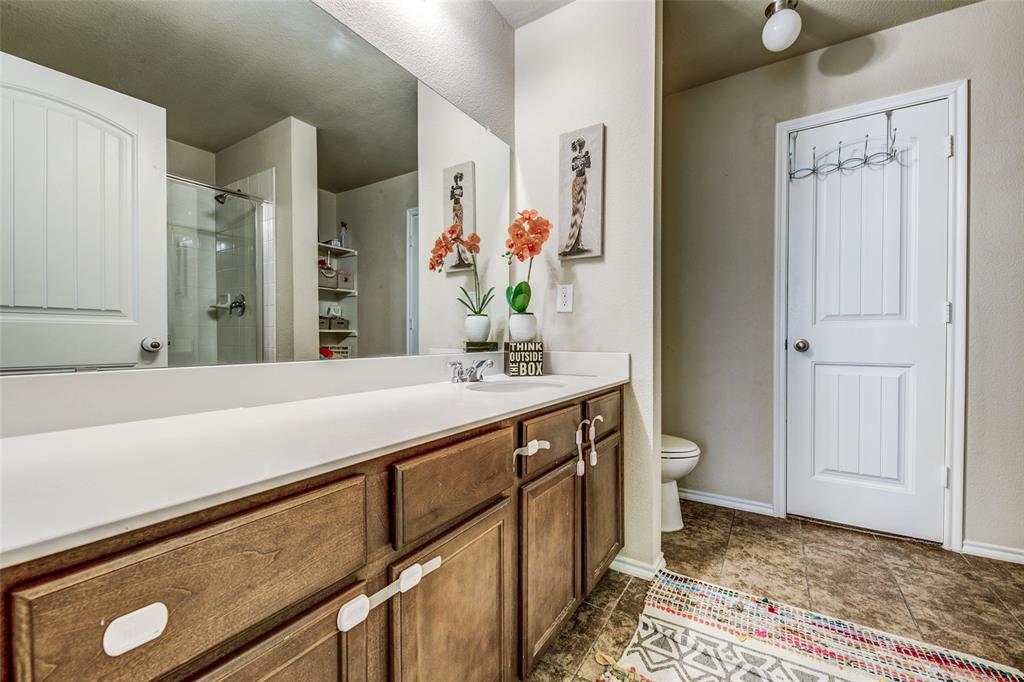 1774 Pioneer Way Lancaster, TX 75146 - Photo 18 of 23 a bathroom with a sink a toilet and mirror