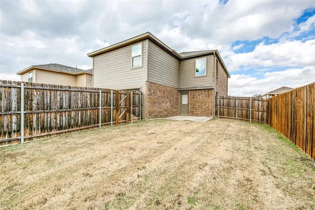 a view of a house with wooden fence