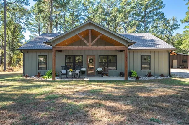 a front view of a house with a yard and porch