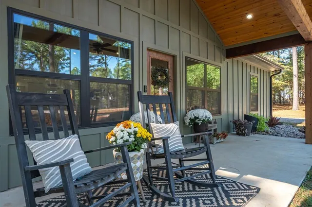 a kitchen with stainless steel appliances a dining table chairs stove refrigerator and cabinets