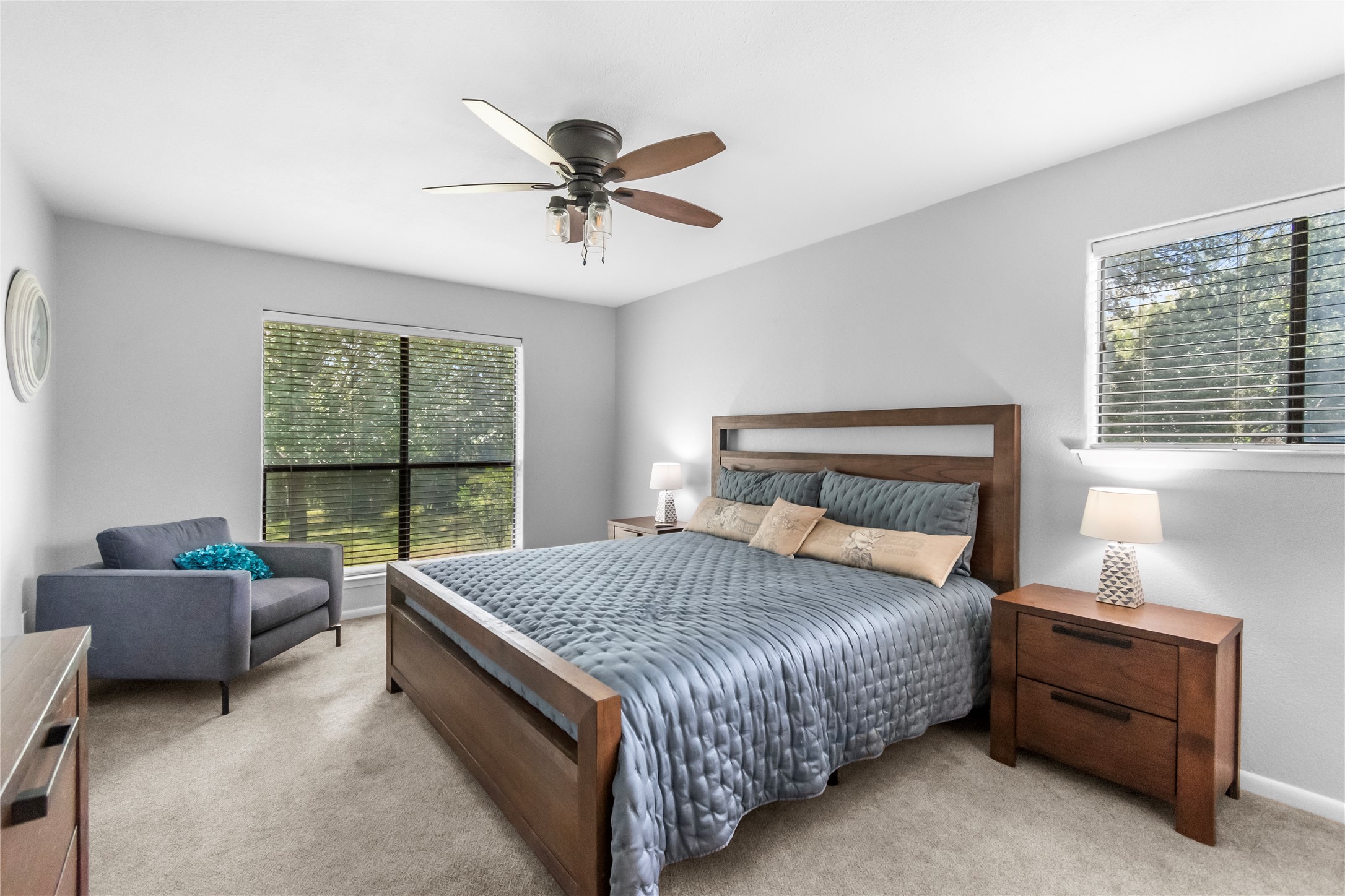 210 Teeoff, Unit B Horseshoe Bay, TX 78657 - Photo 16 of 38 Relaxation awaits in this sun-drenched bedroom, featuring plush carpeting and a modern ceiling fan.
