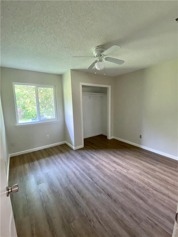 1715 Shadowview Drive, Unit B Austin, TX 78758 - Photo 26 of 28 A quiet bedroom featuring resilient wood flooring and ample natural light from a generous window.