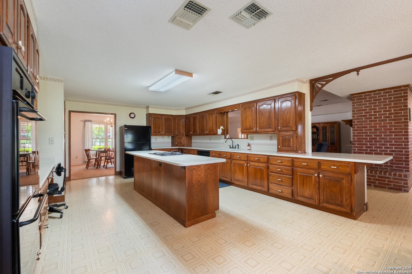 1221 Pieper Road New Braunfels, TX 78130 - Photo 12 of 43 a large kitchen with stainless steel appliances lots of counter space and windows