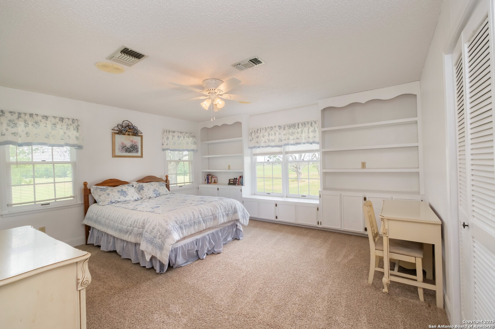 1221 Pieper Road New Braunfels, TX 78130 - Photo 24 of 43 a spacious bedroom with a bed and a window