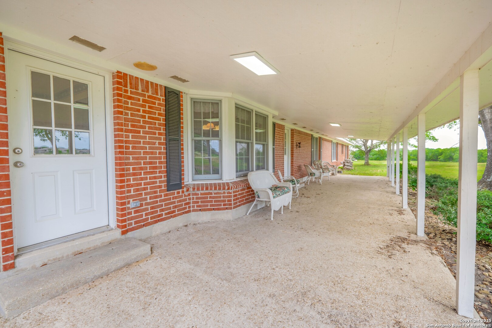1221 Pieper Road New Braunfels, TX 78130 - Photo 35 of 43 a view of an empty room with floor to ceiling windows and wooden fence