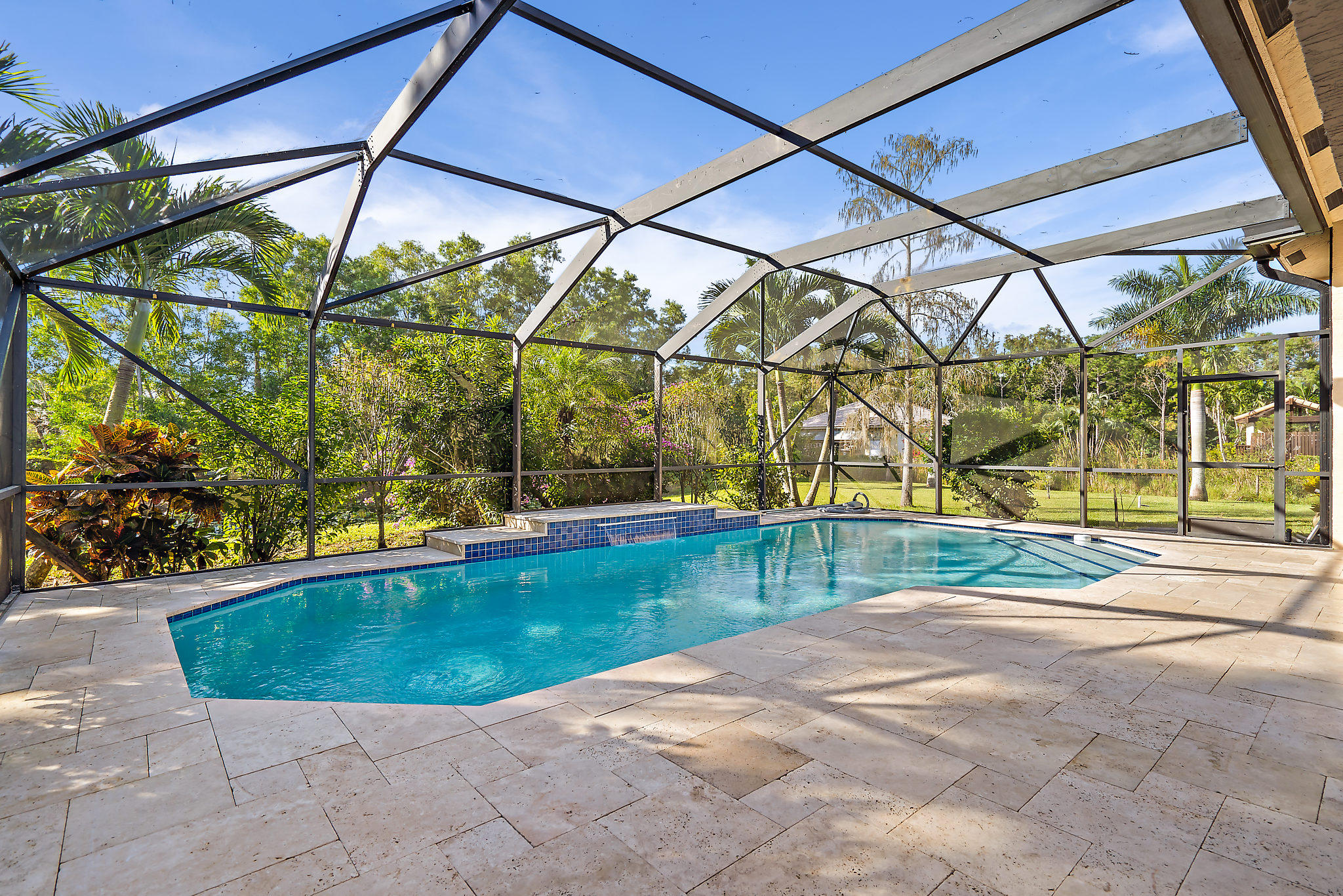 10344 154th Road North Jupiter, FL 33478 - Photo 30 of 50 Screened pool with sandstone deck