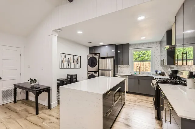 a kitchen with sink cabinets and stove