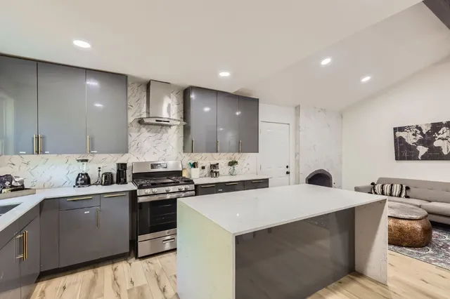 a kitchen with a sink a stove and cabinets