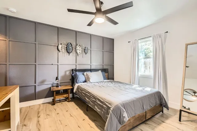 a bedroom with a bed a desk and chair