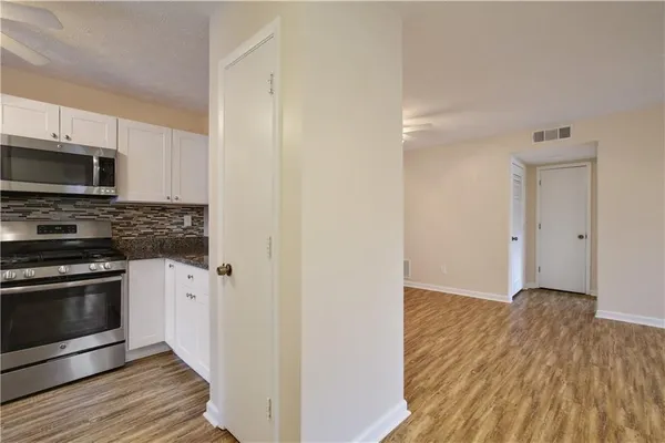 a view of a kitchen with a sink and a fireplace