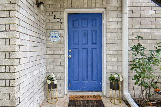 a front view of a house with potted plants