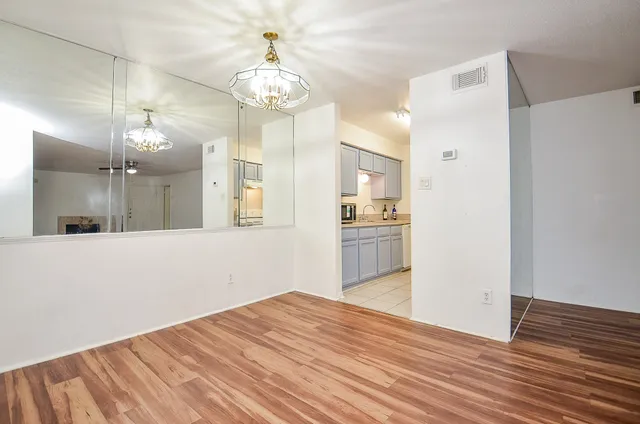 a view of a kitchen with wooden floor and a refrigerator