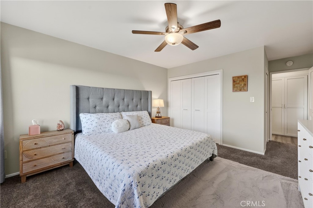 12200 Montecito Road, Unit B315 Seal Beach, CA 90740 - Photo 11 of 30 a bedroom with a bed and a ceiling fan