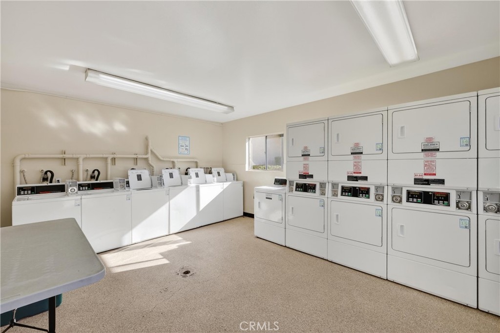 12200 Montecito Road, Unit B315 Seal Beach, CA 90740 - Photo 17 of 30 a large white kitchen with white cabinets and white appliances