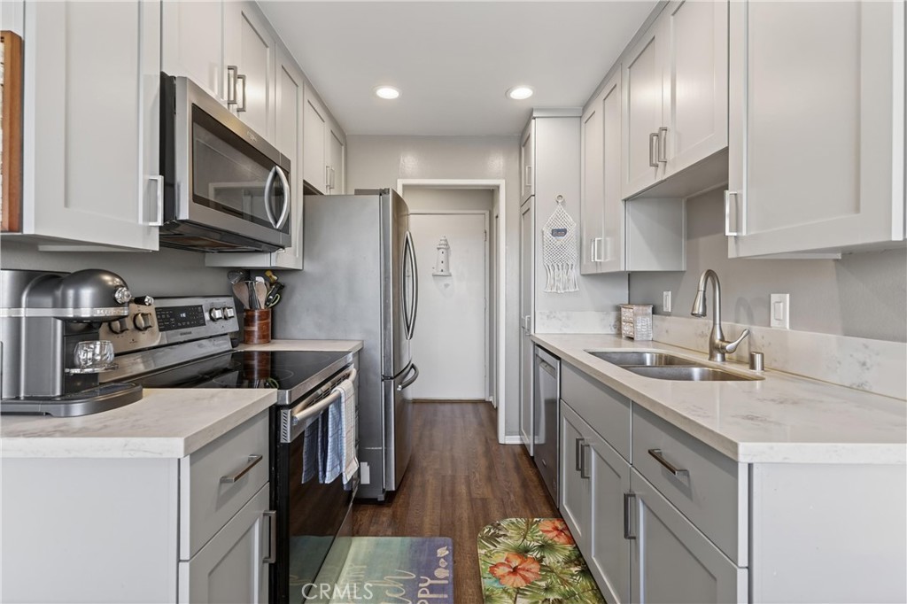12200 Montecito Road, Unit B315 Seal Beach, CA 90740 - Photo 5 of 30 a kitchen with stainless steel appliances granite countertop a sink stove and refrigerator