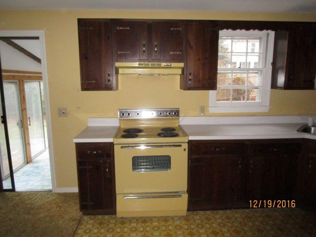 64 McNamara Road West Yarmouth, MA 02673 - Photo 5 of 14 a kitchen with a stove and a cabinet