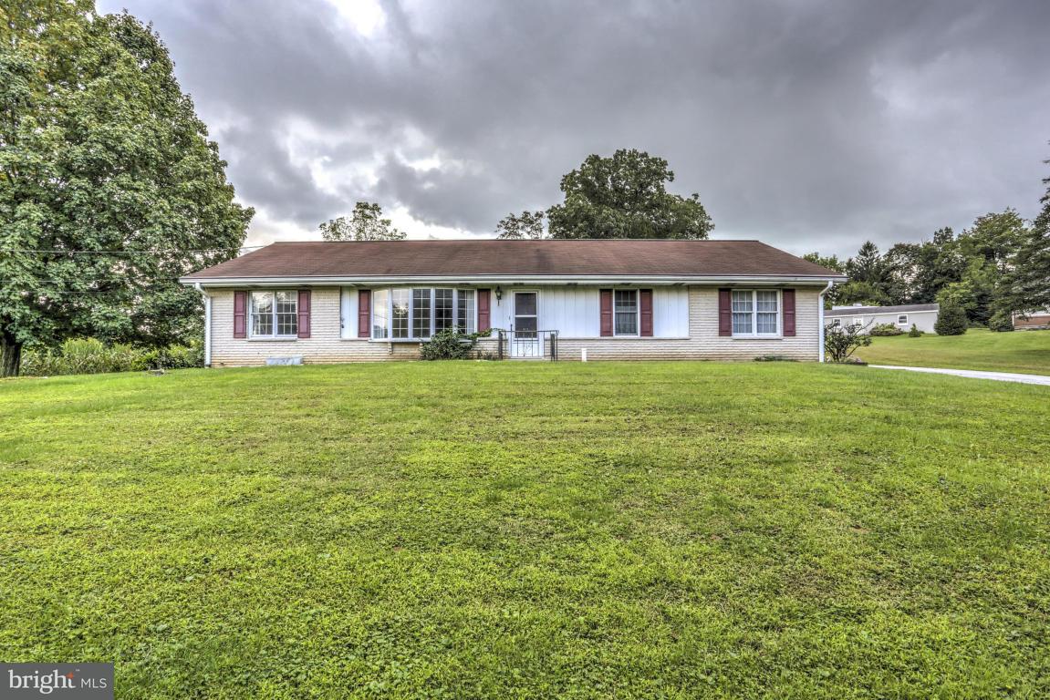 411 South Belmont Road Paradise, PA 17562 - Photo 1 of 25 a front view of a house with a garden and trees