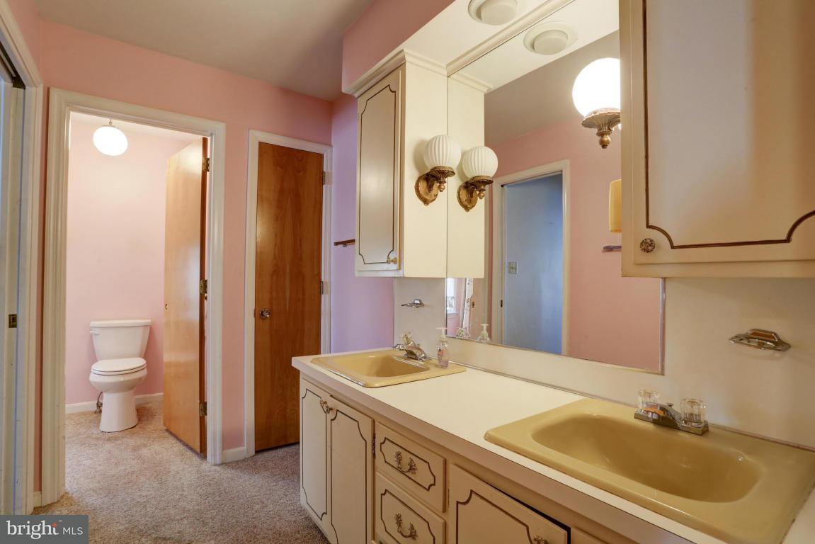 411 South Belmont Road Paradise, PA 17562 - Photo 18 of 25 a bathroom with a sink and a mirror