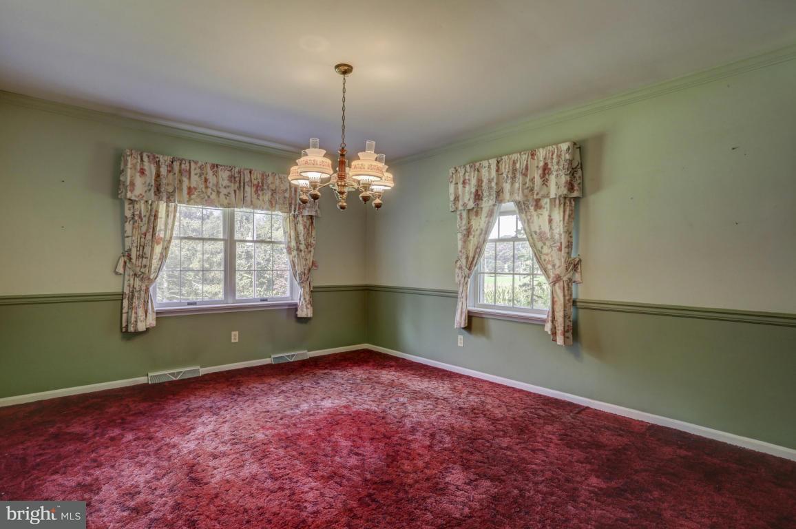 411 South Belmont Road Paradise, PA 17562 - Photo 5 of 25 a view of an empty room with window and chandelier fan
