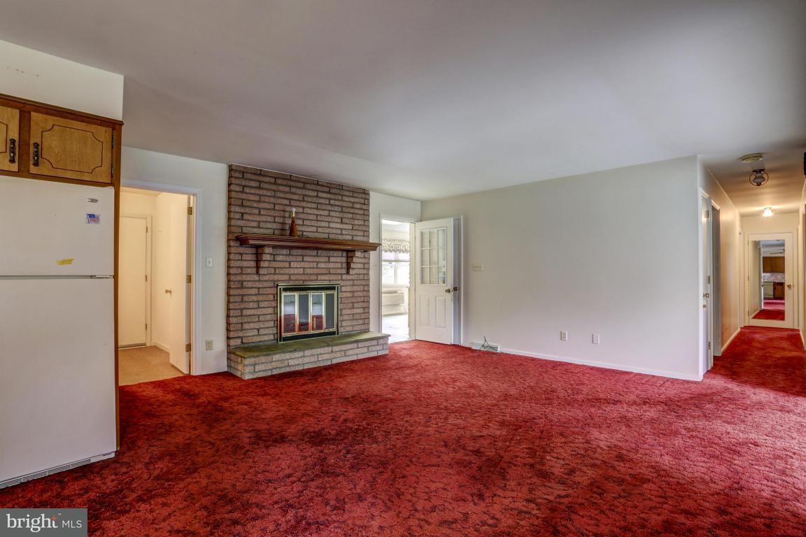411 South Belmont Road Paradise, PA 17562 - Photo 9 of 25 a view of an empty room with a fireplace and a window