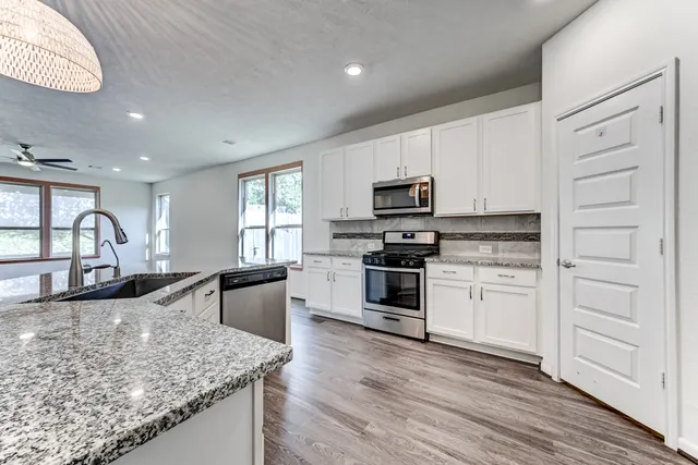 a kitchen with a stove a sink and a refrigerator