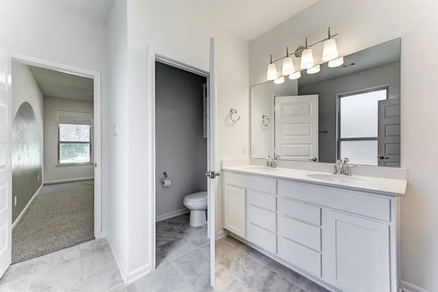 a bathroom with a double vanity sink and a mirror