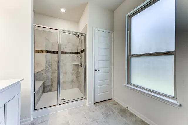 a bathroom with a glass shower door