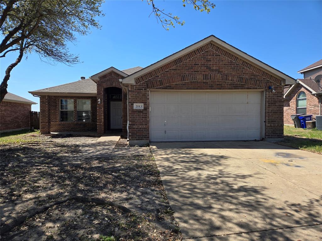 2113 Chisolm Trail Forney, TX 75126 - Photo 1 of 5 Ranch-style house with a garage, brick siding, concrete driveway, and a shingled roof