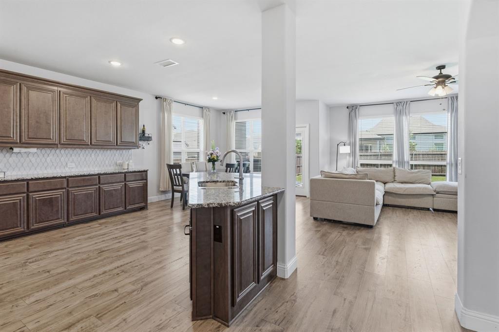 1316 Tree Shadow Lane Anna, TX 75409 - Photo 12 of 40 This kitchen has tons of counter top space and storage. The island is perfectly situated for keeping up with everyone in the large open concept living space.
