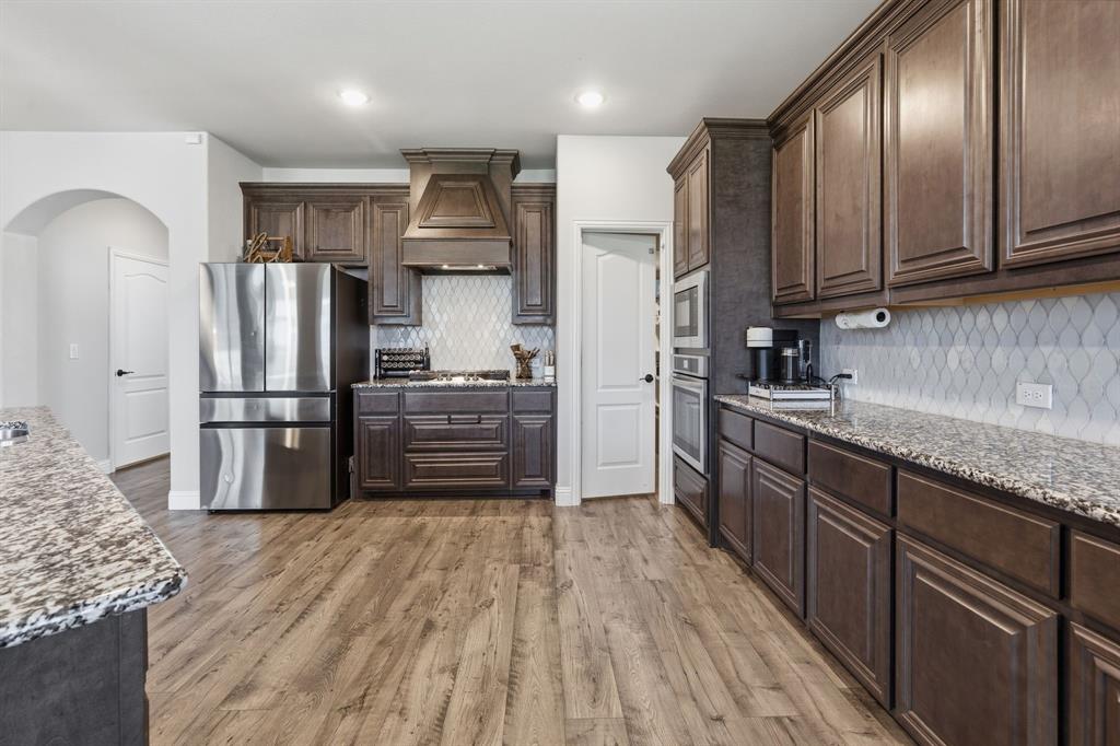 1316 Tree Shadow Lane Anna, TX 75409 - Photo 13 of 40 A giant walk-in pantry is at the corner of the kitchen. And look at the space in this kitchen!