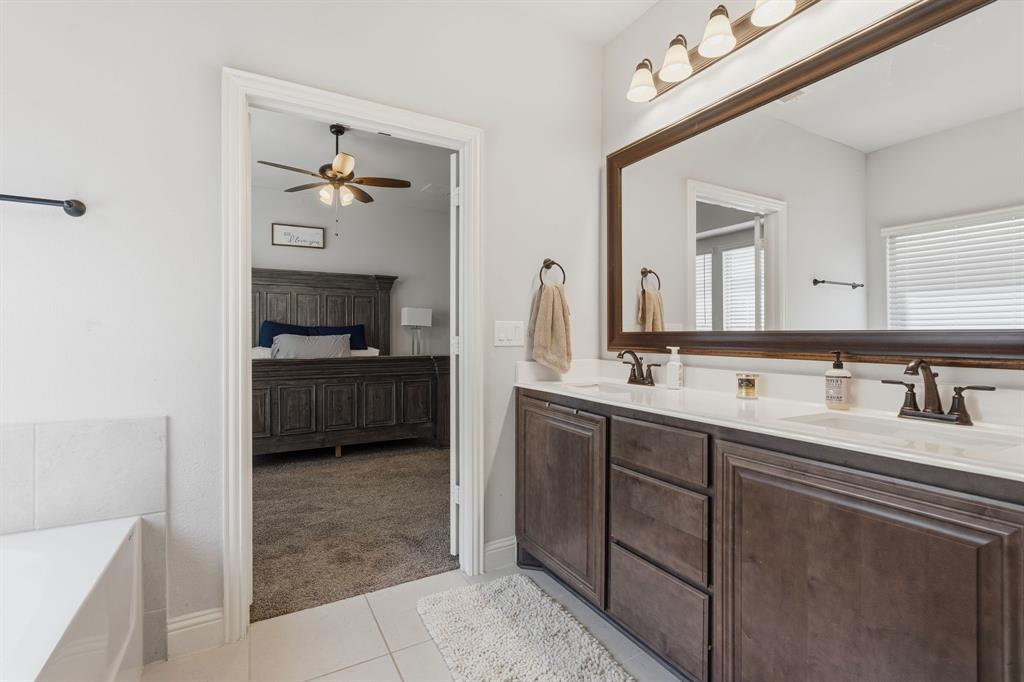 1316 Tree Shadow Lane Anna, TX 75409 - Photo 23 of 40 Dual sinks, soaking tub and separate shower in the ensuite bath. A large walk-in closet as well.