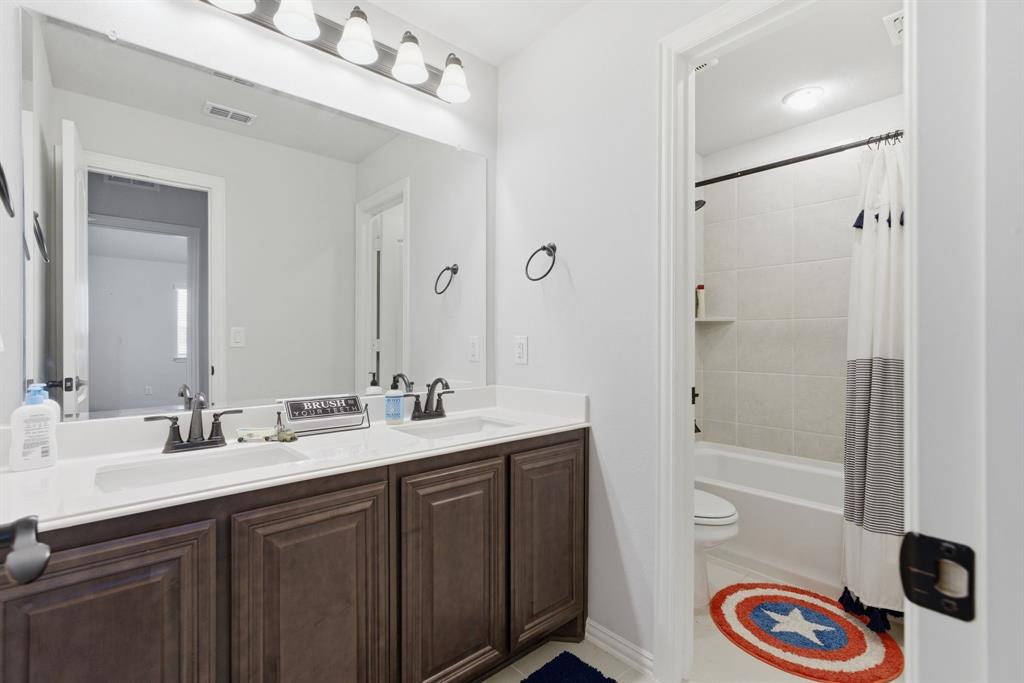 1316 Tree Shadow Lane Anna, TX 75409 - Photo 29 of 40 Upstairs hall bath with dual sinks and separation for the shower/tub and toilet area.