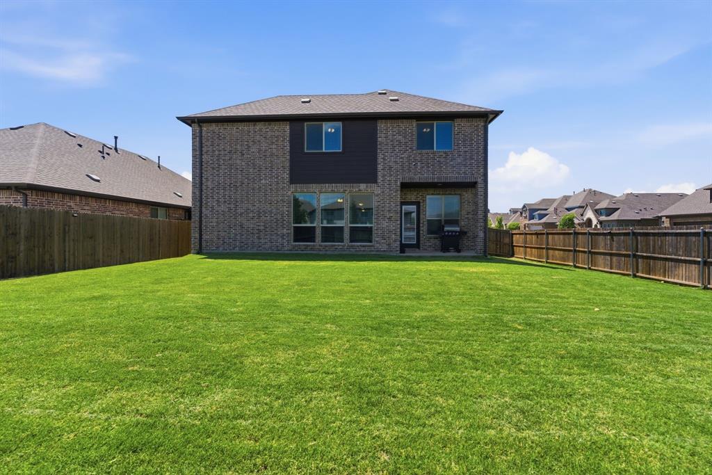 1316 Tree Shadow Lane Anna, TX 75409 - Photo 34 of 40 Covered patio, fully fenced and manicured backyard to enjoy!