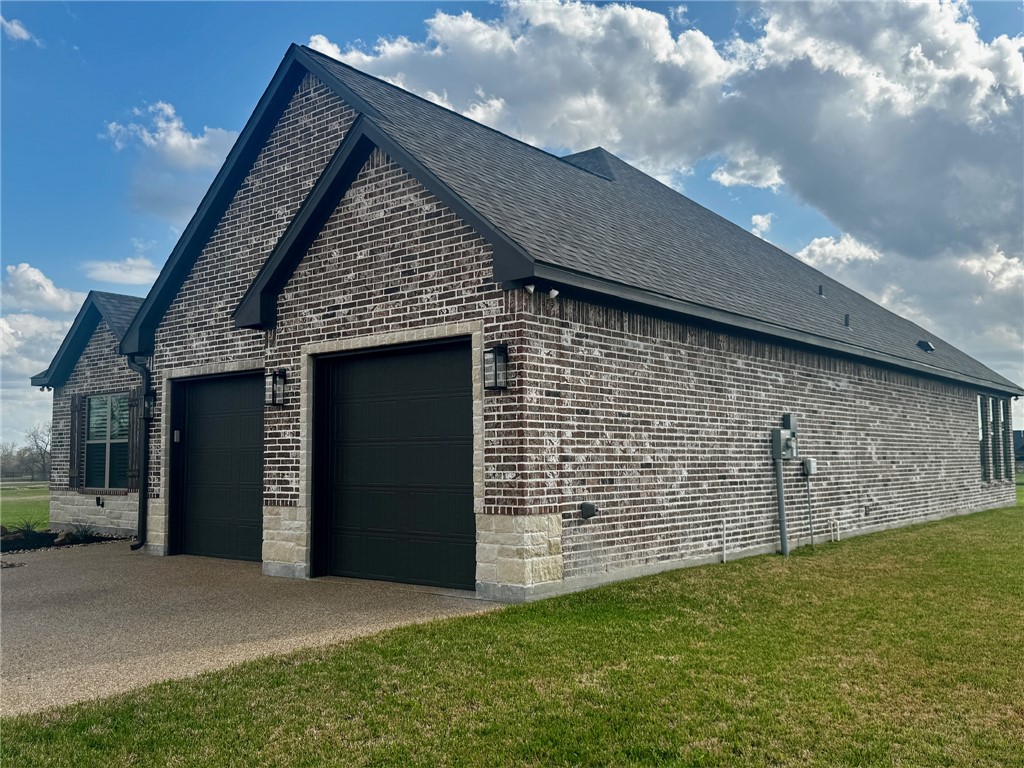 5854 Reliance Rdg Circle Bryan, TX 77808 - Photo 11 of 32 a front view of a house with a yard