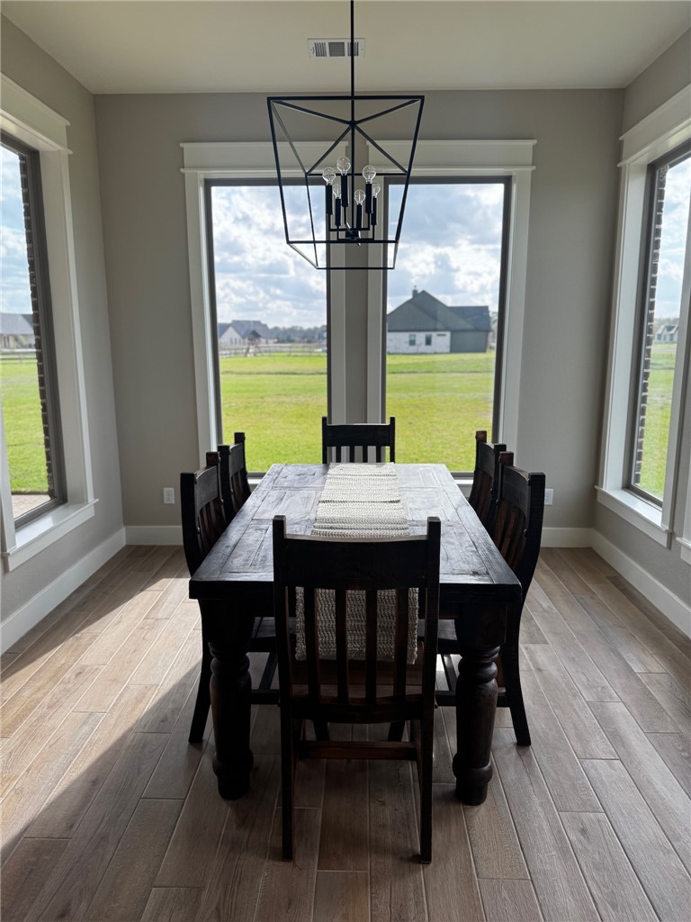 5854 Reliance Rdg Circle Bryan, TX 77808 - Photo 15 of 32 a view of a dining room with furniture window and wooden floor