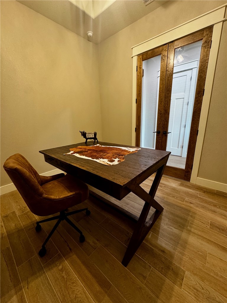 5854 Reliance Rdg Circle Bryan, TX 77808 - Photo 20 of 32 a view of a workspace with furniture and wooden floor