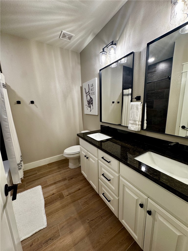 5854 Reliance Rdg Circle Bryan, TX 77808 - Photo 26 of 32 a spacious bathroom with a double vanity sink and a mirror