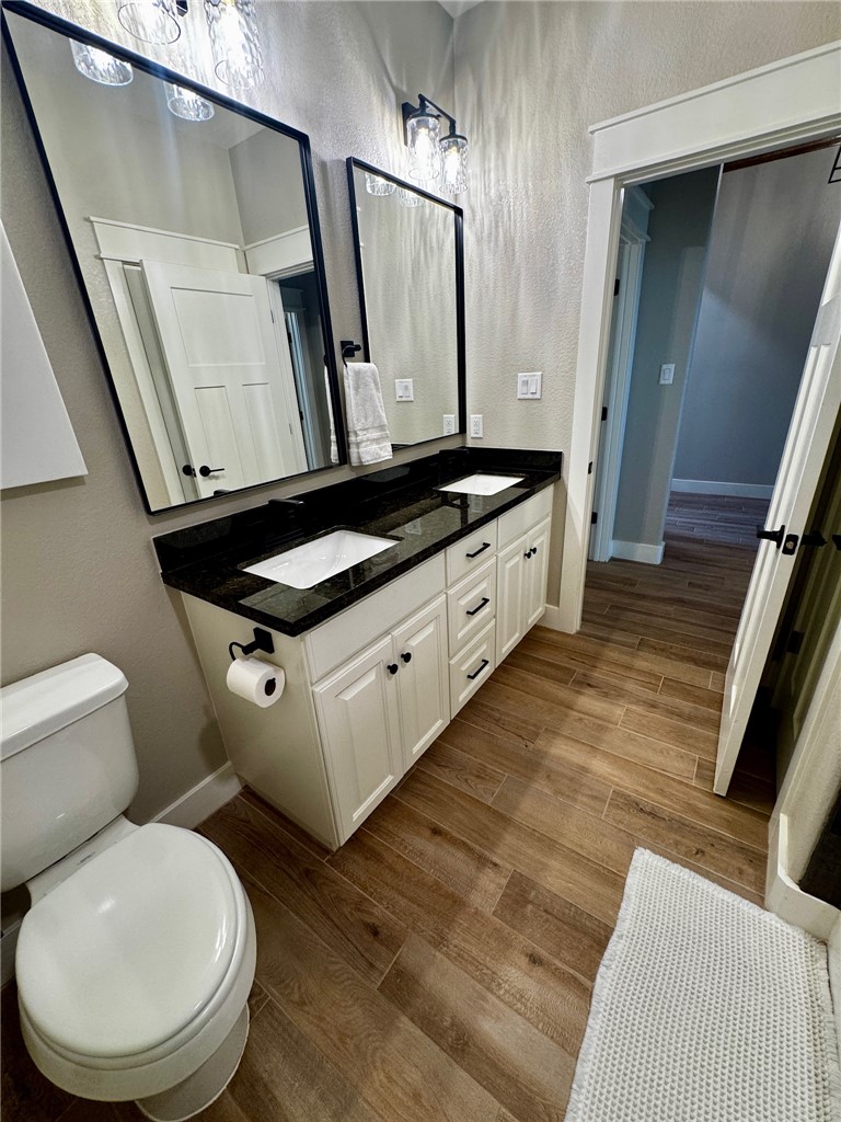 5854 Reliance Rdg Circle Bryan, TX 77808 - Photo 28 of 32 a bathroom with a toilet sink and mirror