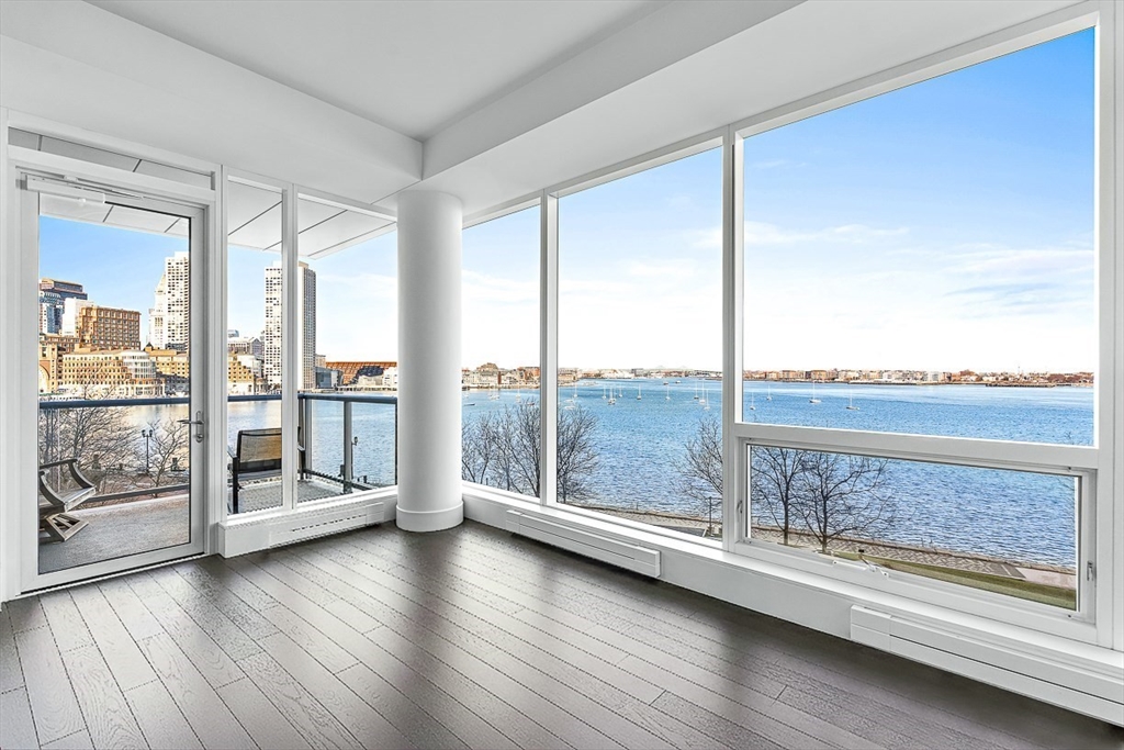 a view of workspace with furniture and floor to ceiling window