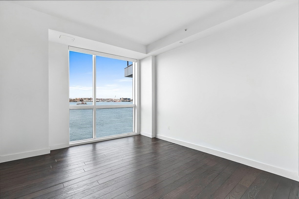 22 Liberty Drive, Unit 4D Boston, MA 02210 - Photo 11 of 21 an empty room with wooden floor