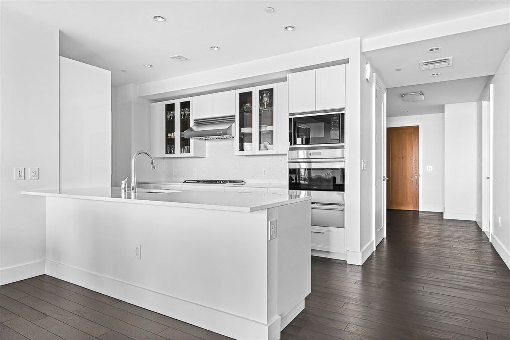 22 Liberty Drive, Unit 4D Boston, MA 02210 - Photo 9 of 21 a kitchen with stainless steel appliances granite countertop a stove and a refrigerator