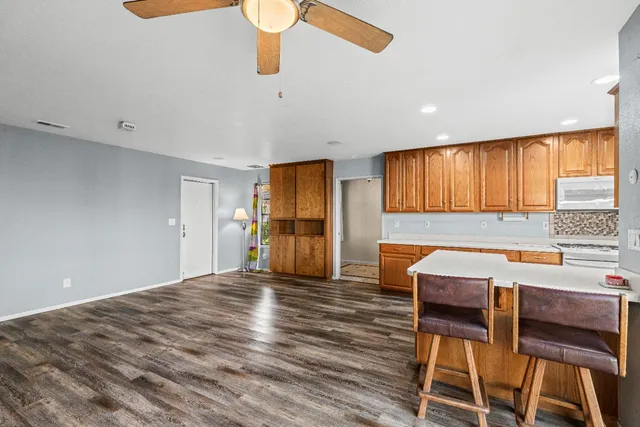 a kitchen with stainless steel appliances granite countertop wooden cabinets a sink and dishwasher a refrigerator with wooden cabinets