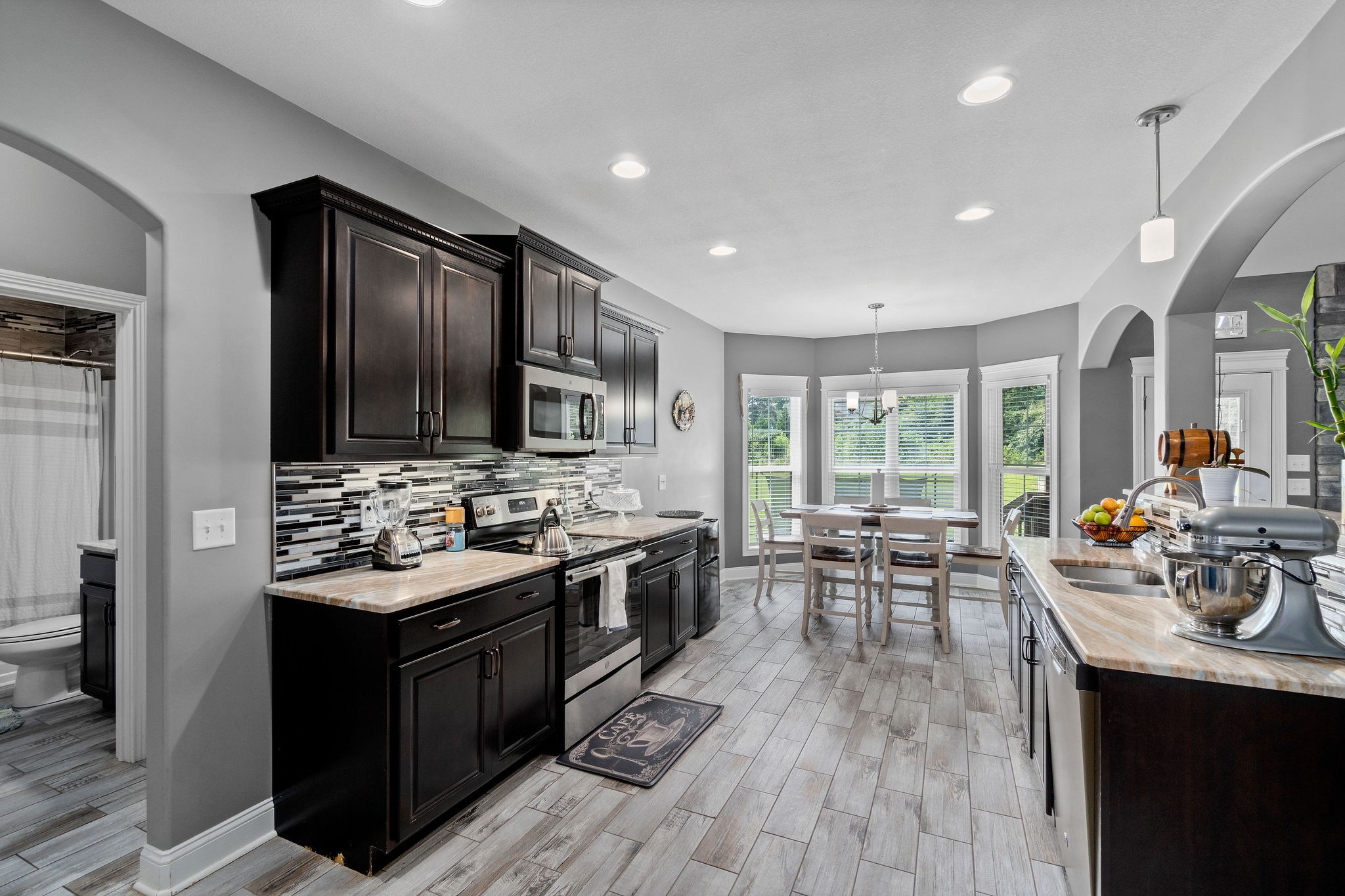 3508 Drake Road Adams, TN 37010 - Photo 12 of 35 a kitchen with counter top space a sink appliances and living room view