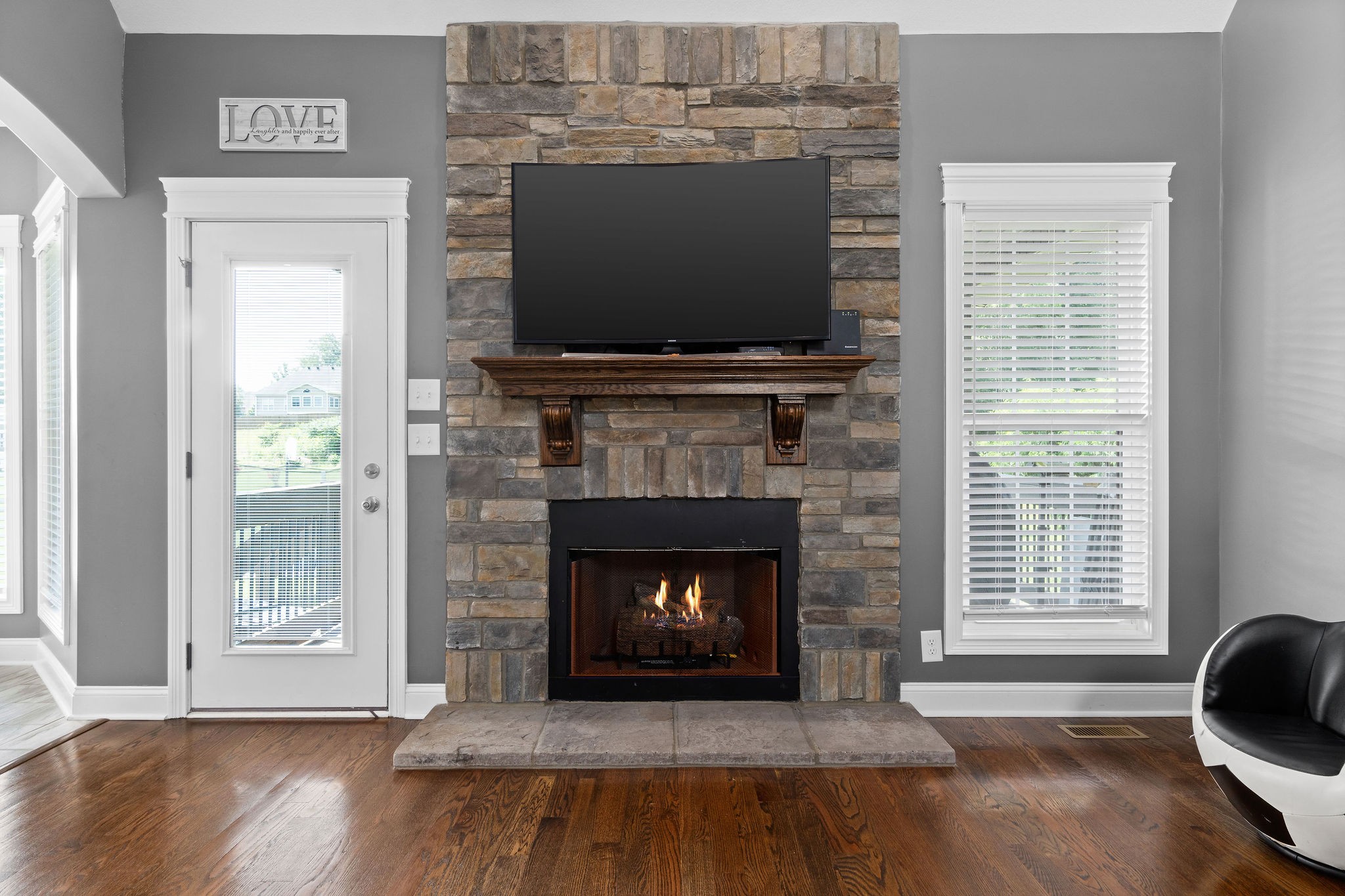 3508 Drake Road Adams, TN 37010 - Photo 10 of 35 a living room with a fireplace and a flat screen tv