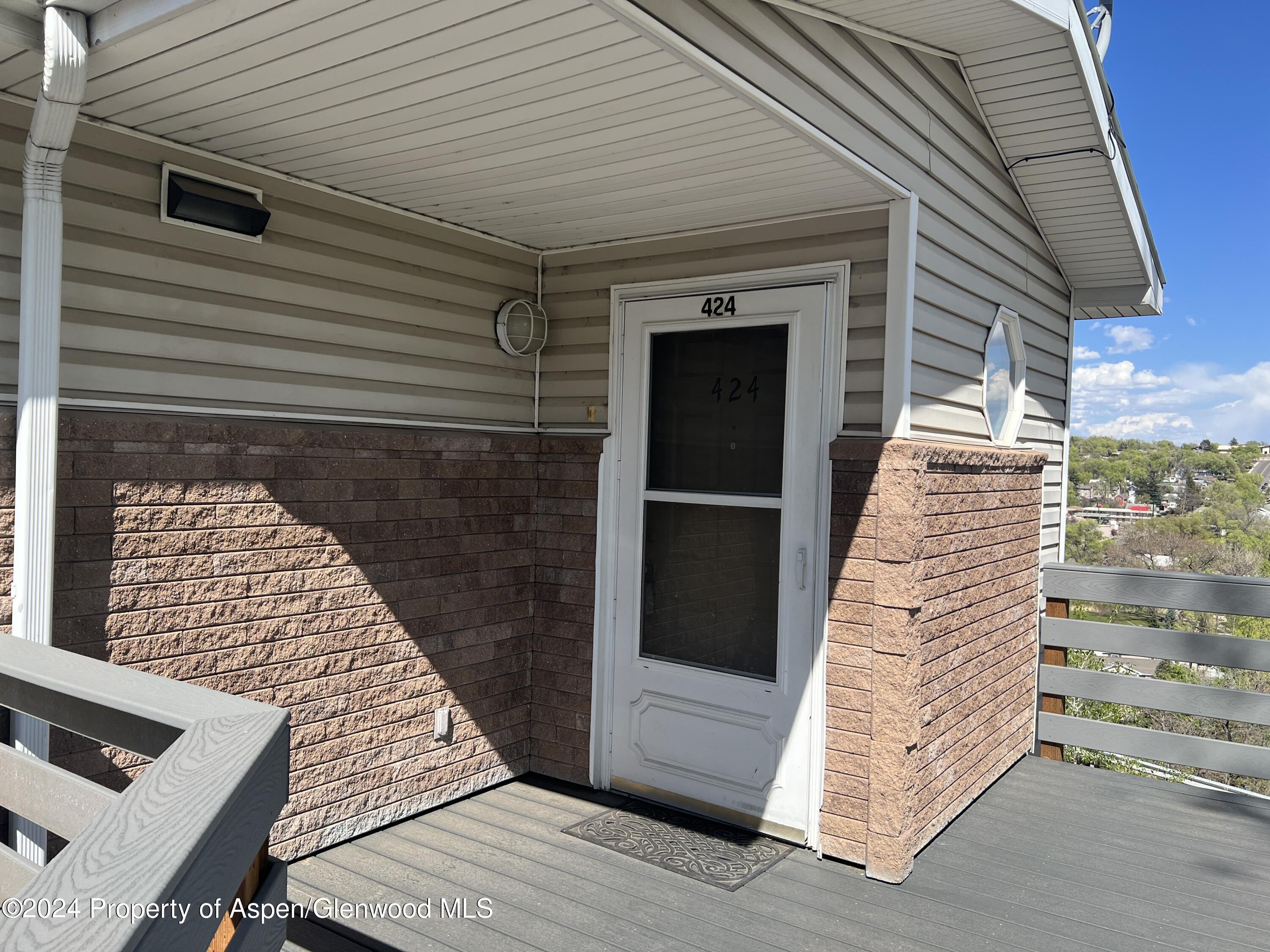 424 Lind Avenue Rifle, CO 81650 - Photo 1 of 24 a view of a balcony with wooden floor and fence