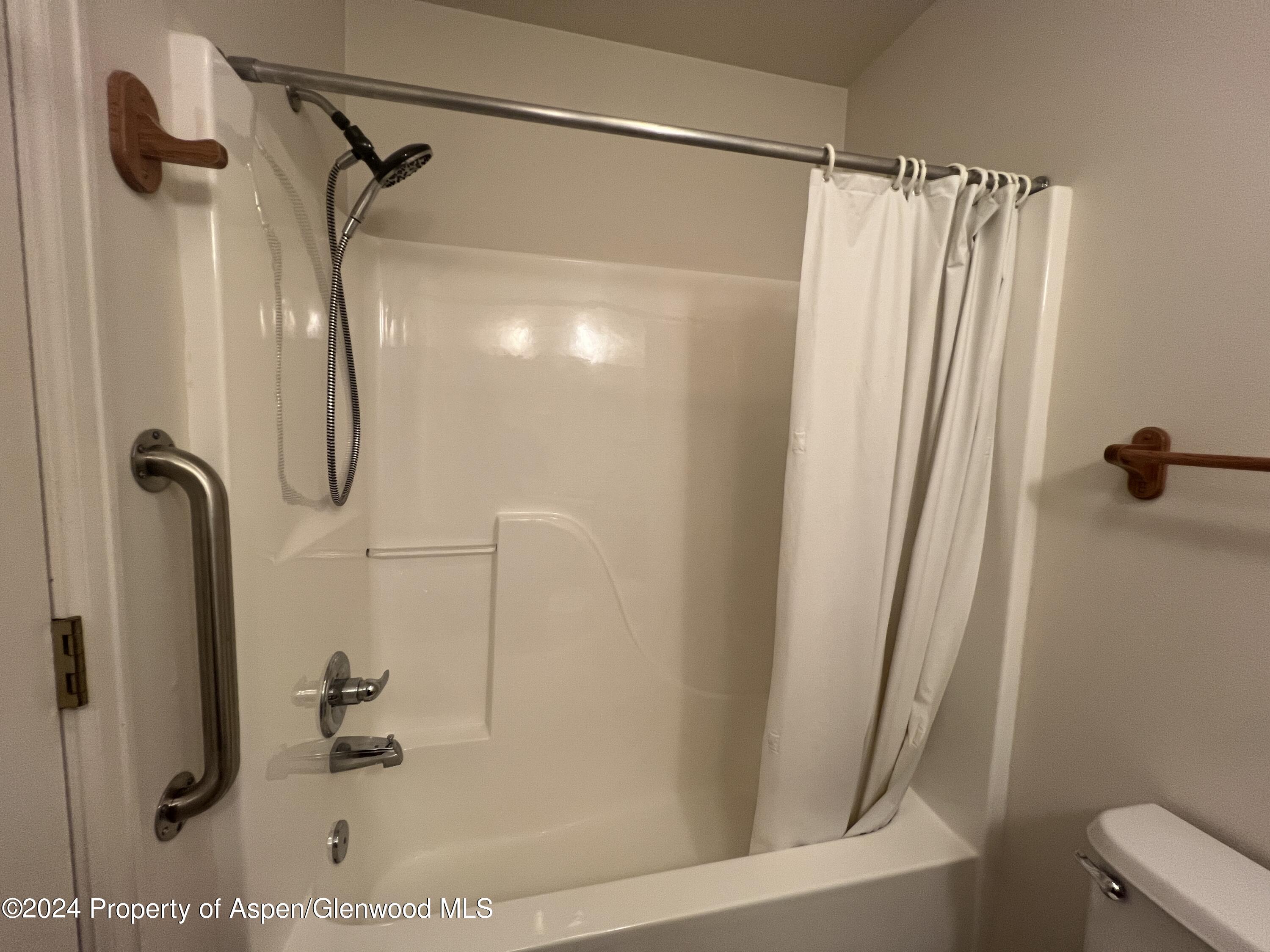 424 Lind Avenue Rifle, CO 81650 - Photo 13 of 24 a bathroom with a shower and a tub