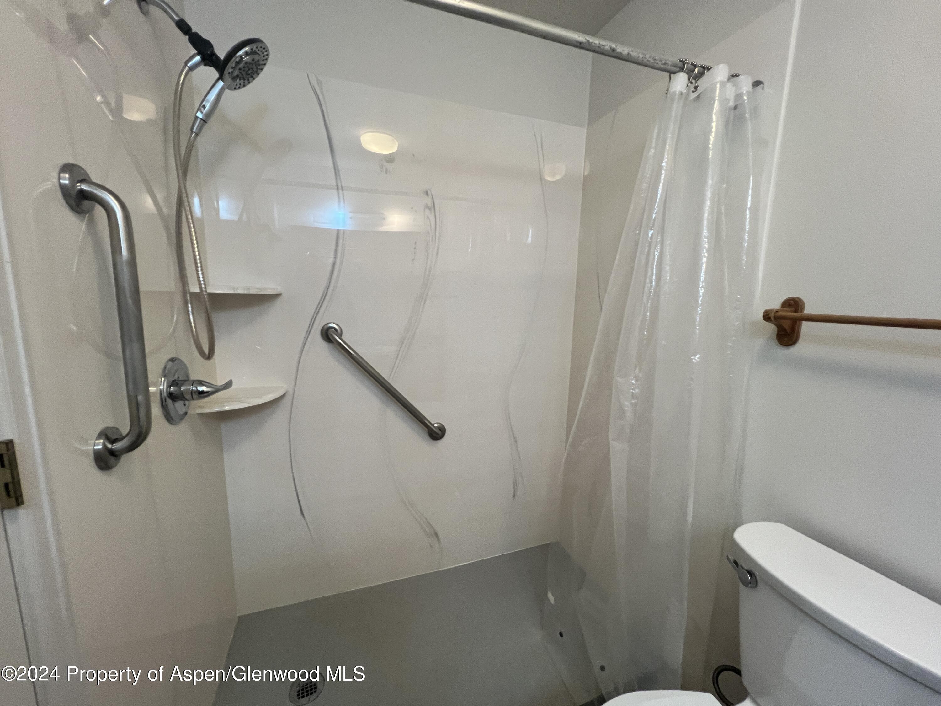 424 Lind Avenue Rifle, CO 81650 - Photo 21 of 24 a bathroom with a shower a toilet and sink
