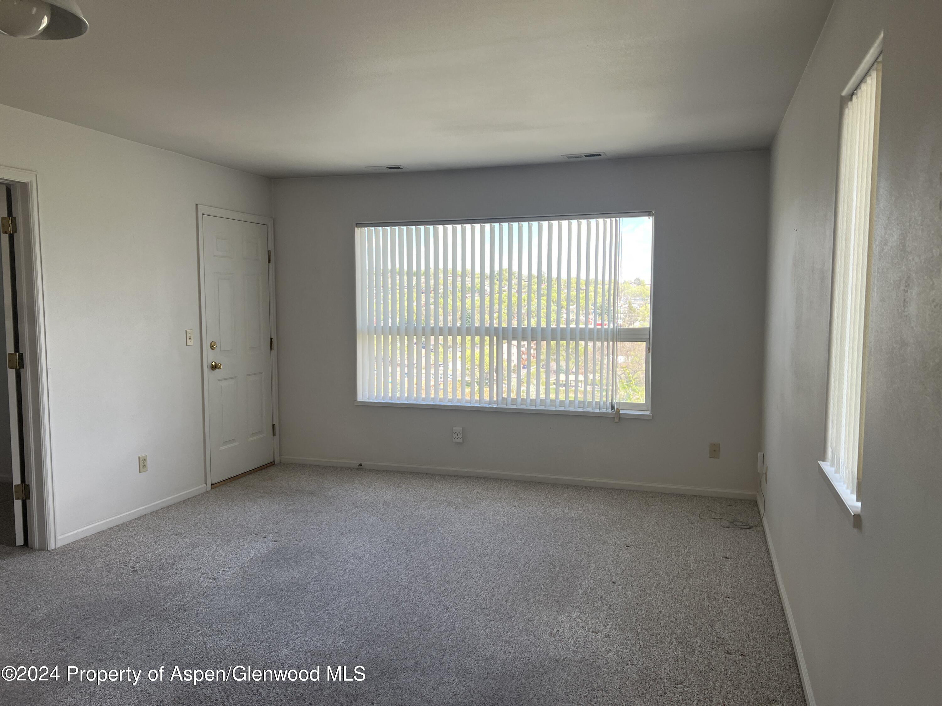 424 Lind Avenue Rifle, CO 81650 - Photo 4 of 24 a view of an empty room with a window